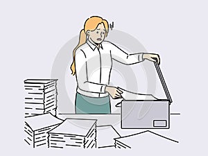 Stressed female employee duplicate paperwork in copy machine photo