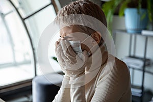 Stressed female employee got infected by coronavirus, suffering from symptoms.