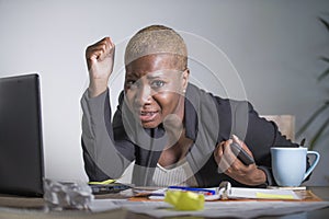 Stressed and frustrated afro American black woman working overwhelmed and upset at office laptop computer desk gesturing desperate