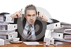 Stressed frustrated business man with telephones