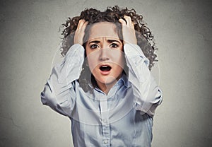 Stressed, frustrated shocked business woman pulling hair out