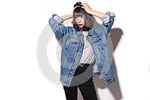 Stressed frustrated woman covering her ears not wanting to hear anybody pressing teeth isolated over white background