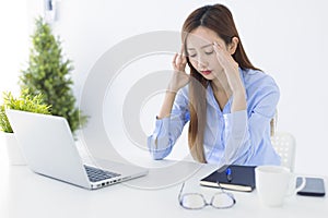 Stressed and headache asian business woman working in office