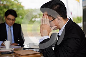 Stressed headache businessman sit near manager