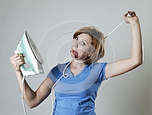 Stressed housewife or maid domestic service woman holding upset iron strangling neck with cable photo