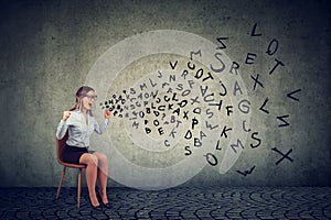 Stressed isolated female employee sitting on a chair screaming in frustration