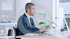 Stressed male business manager with a work headache on a computer. Frustrated office worker taking off his glasses while