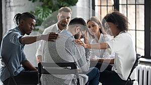 Stressed male get support from diverse people at session