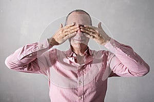 Stressed man with hands in front of eyes