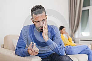 Stressed man holding her wedding ring worried about breakup or divorce, avoid talking with wife after fight, anxious couple ignore