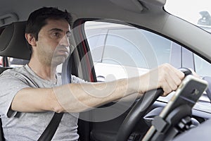 Stressed man huffing and puffing while driving photo