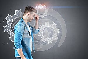 Stressed man in jeans shirt, gears