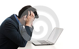 Stressed man looking at his laptop computer