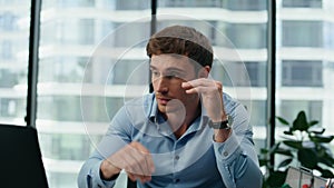 Stressed man manager confused by mistake in documents looking papers close up.