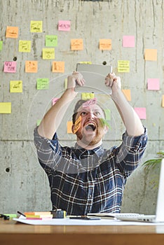 Stressed man with message on sticky notes