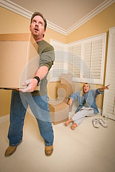 Stressed Man Moving Boxes for Demanding Wife