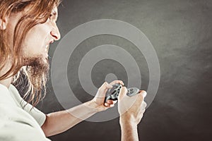 Stressed man playing on pad