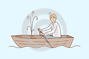 Stressed man sailing in boat with leakage