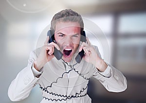 Stressed man on telephones in office