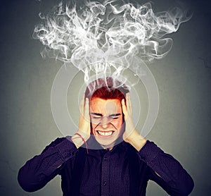 Stressed man thinks intensely having headache