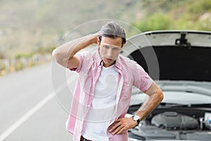 Stressed man waiting assistance after a car breakdown