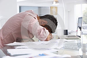 Stressed Man Working At Laptop In Home Office