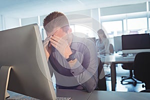 Stressed mature student sitting at desk