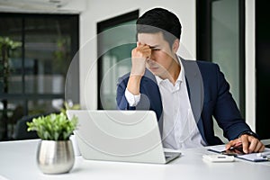 Stressed Asian businessman pensive thinking a plan to solve the problem