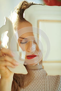 Stressed modern housewife with broken dish near Christmas tree