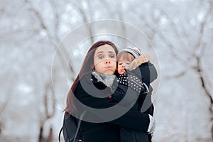 Stressed Mom Holding Baby Girl in Cold Weather
