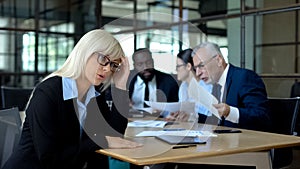 Stressed office manager listening to arguing colleagues, occupational burnout