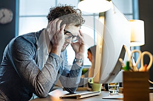 Stressed office worker with headache