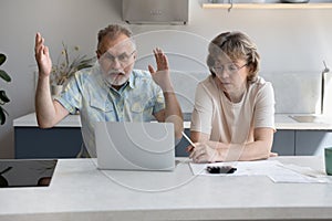 Stressed old family couple having financial problems.
