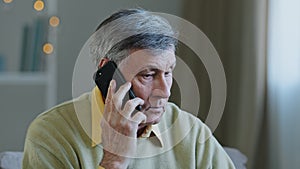 Stressed old man worried Caucasian senior mature grandfather hearing awful news at mobile phone call conversation