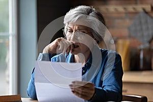 Stressed older latin woman get bad surprise reading official letter