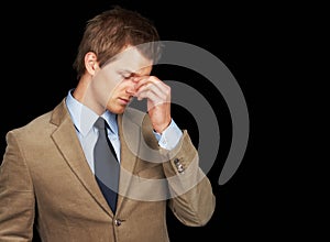 Stressed out business man over black background. Stressed out young business man over black background.