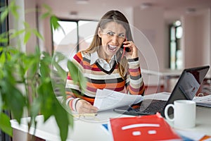 Stressed out business woman screaming on the phone