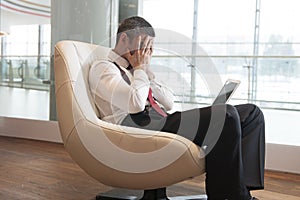 Stressed out businessman covers face with hands photo