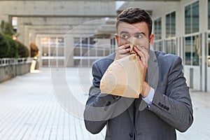 Stressed out man breathing through paper bag