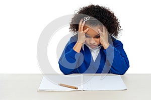 Stressed out primary girl child holding her head photo