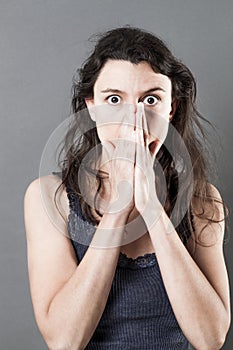 Stressed out woman hiding her mouth for mistake or consternation