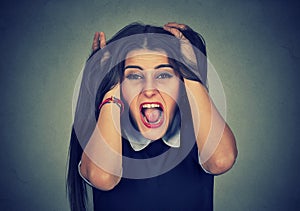 Stressed out young woman pulling her hair