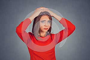 Stressed out young woman with worried face expression looking