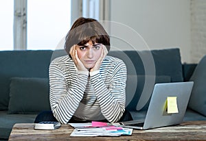 Stressed and overwhelmed young woman trying to manage home finances paying bills feeling desperate