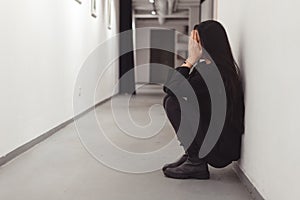 Stressed overworked young business woman sitting on floor. Fired and depressed in office.
