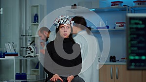 Stressed patient sitting on neurological chair with eeg headset