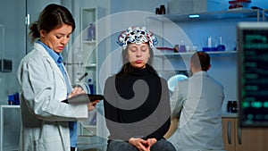 Stressed patient sitting on neurological chair with eeg headset