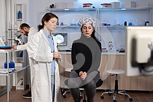 Stressed patient sitting on neurological chair with eeg headset,