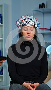 Stressed patient sitting on neurological chair with eeg headset