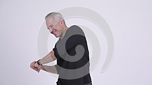Stressed Persian man having back pain against white background